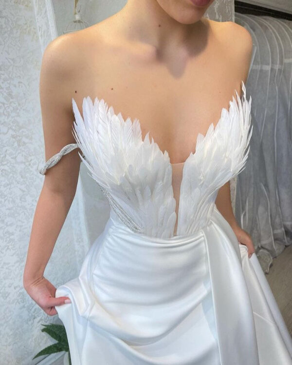 A Dress With Feathers Sweeping The Floor - Image 3